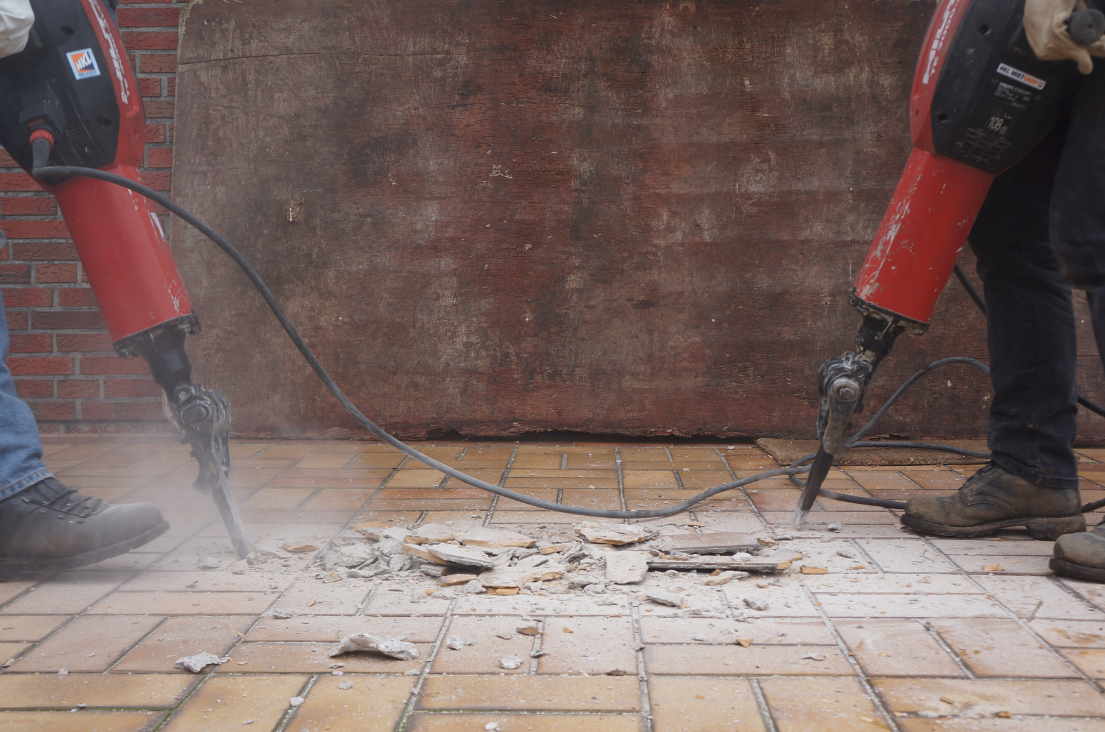 Excavating & Grading New Berlin WI - Workers using jackhammers to break up a tiled floor.