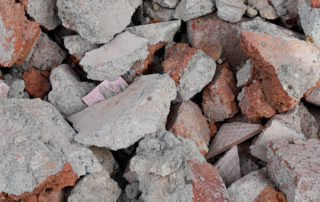 Excavating & Grading Services Muskego WI - Close-up view of a pile of broken concrete and red bricks.